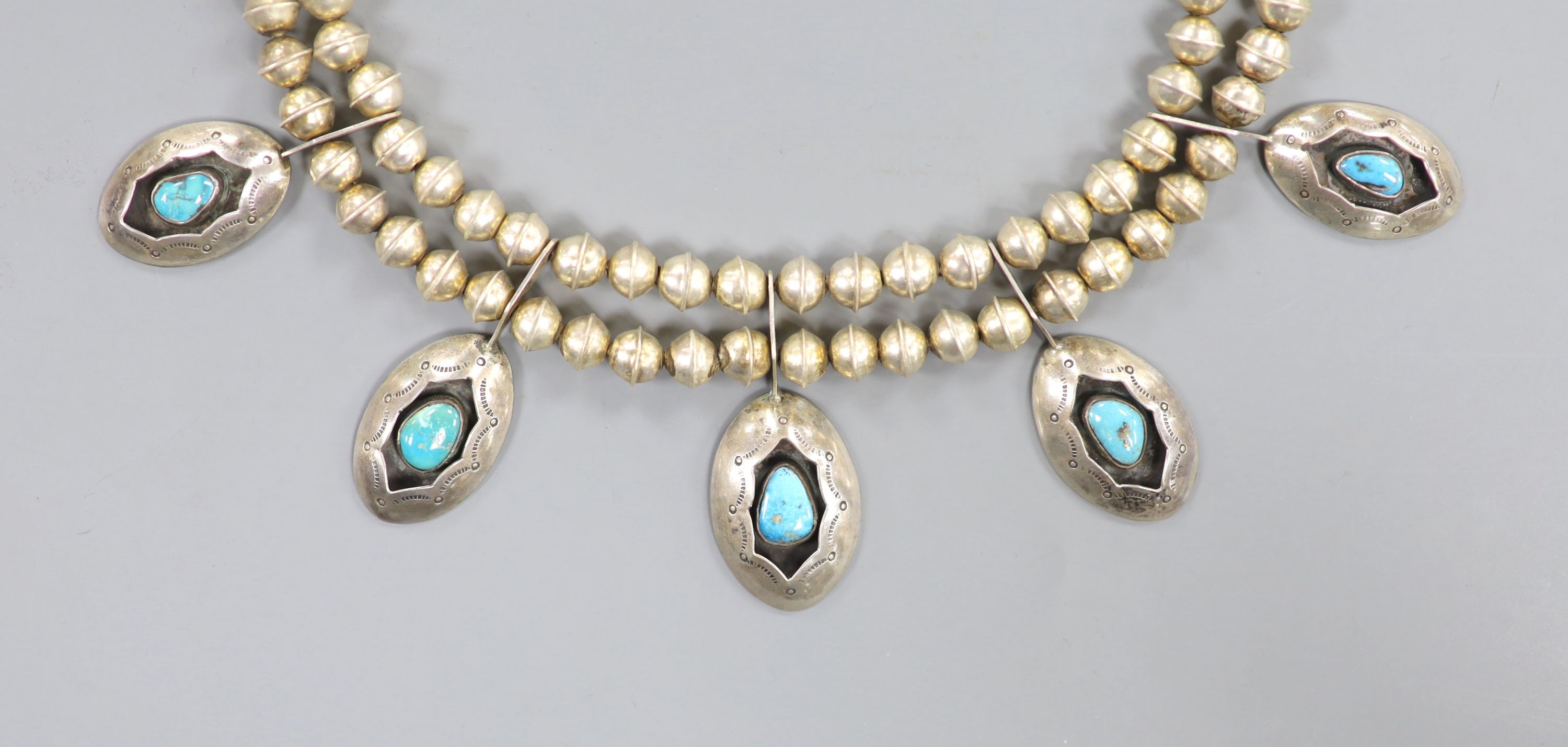 A 20th century South American? white metal and turquoise set drop necklace, approx. 44cm, gross weight 52 grams.